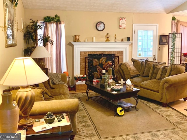 living room featuring a fireplace and a textured ceiling