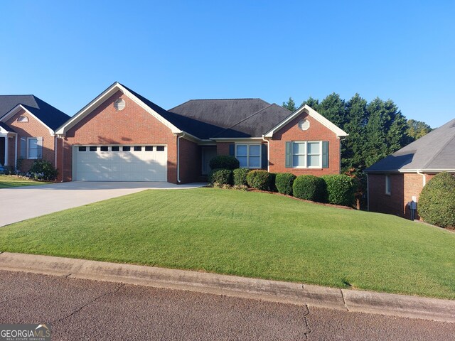 ranch-style home with a garage and a front yard