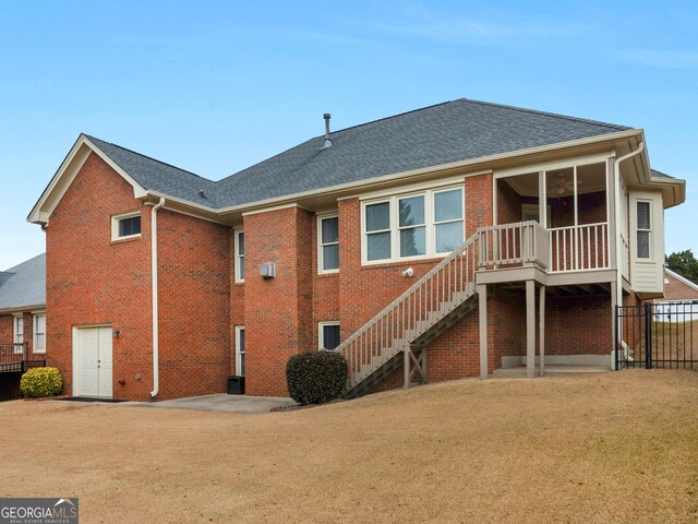 back of house with a lawn and a patio area