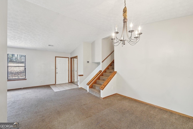 interior space featuring a textured ceiling and a notable chandelier