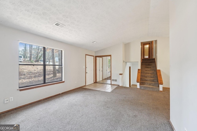 interior space featuring vaulted ceiling and a textured ceiling