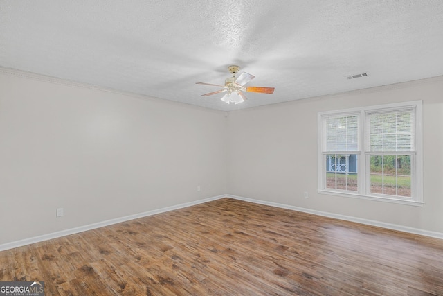 unfurnished room featuring a textured ceiling and hardwood / wood-style flooring