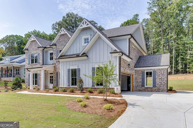 craftsman inspired home with a front yard and a garage