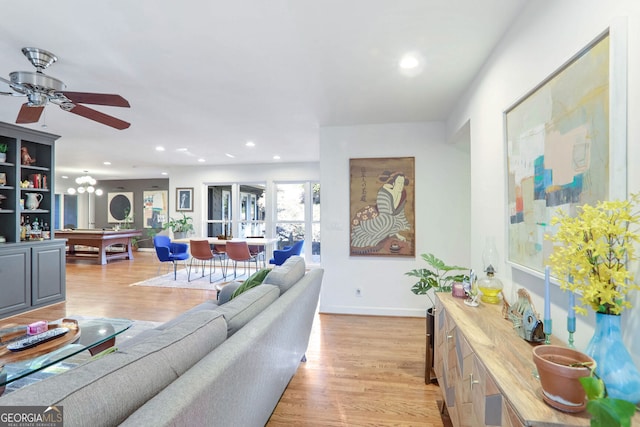 living room with billiards, light hardwood / wood-style floors, and ceiling fan