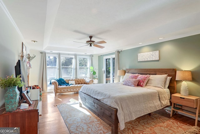 bedroom featuring ceiling fan, ornamental molding, and light hardwood / wood-style floors