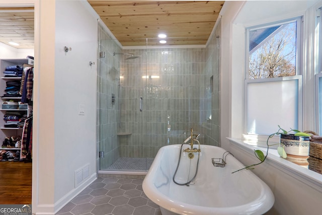 bathroom with tile patterned flooring, shower with separate bathtub, a wealth of natural light, and wood ceiling