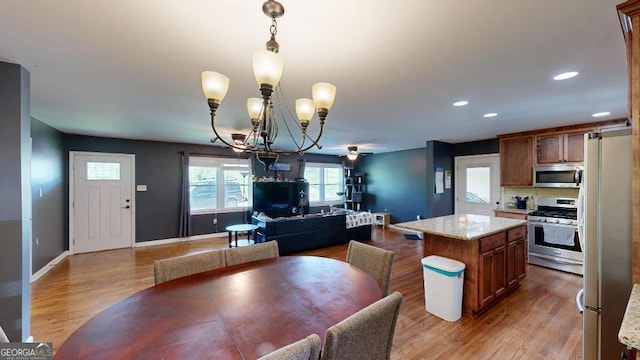 dining space featuring hardwood / wood-style floors and an inviting chandelier