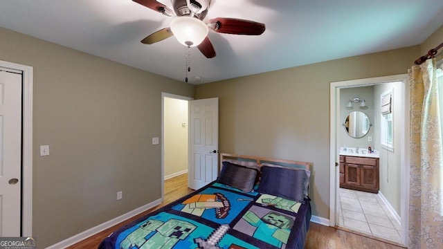 bedroom with ensuite bath, ceiling fan, and wood-type flooring