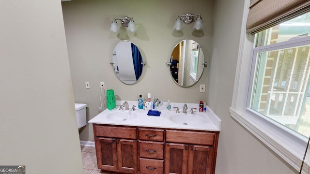 bathroom featuring toilet, vanity, and tile patterned floors