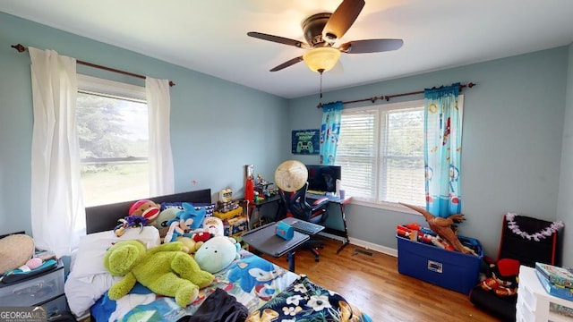 bedroom featuring wood-type flooring and ceiling fan