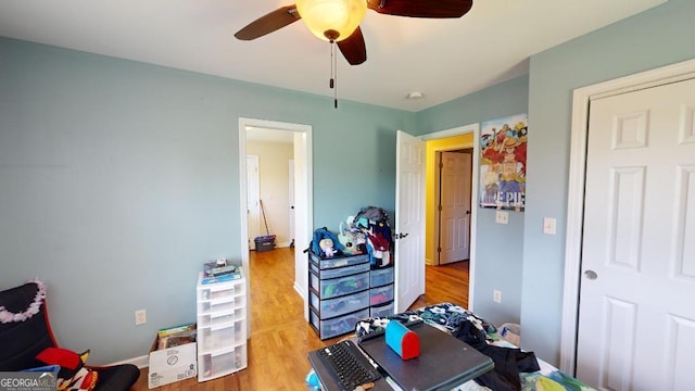 bedroom featuring light hardwood / wood-style floors and ceiling fan