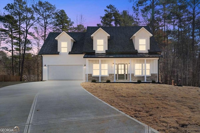 view of front of property with covered porch and a garage