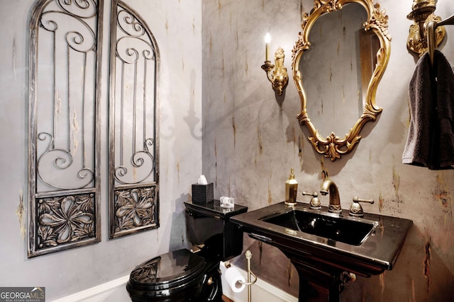 bathroom featuring sink and toilet