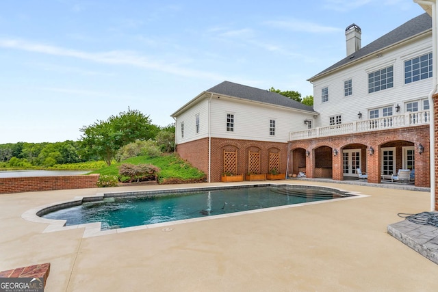 view of pool with a patio and french doors