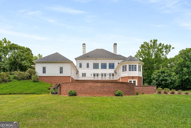 back of property featuring a lawn