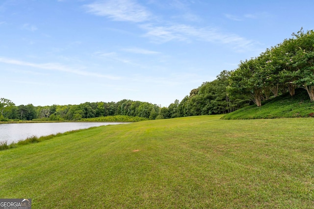 exterior space featuring a lawn and a water view