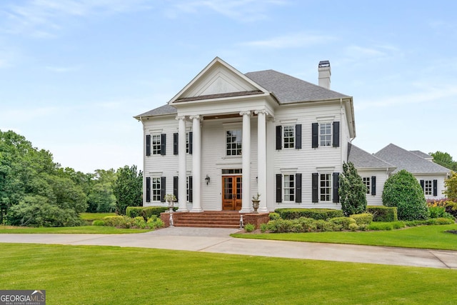 neoclassical home with a front yard