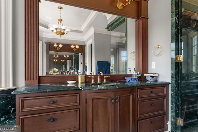 bathroom with a chandelier, vanity, and ornamental molding