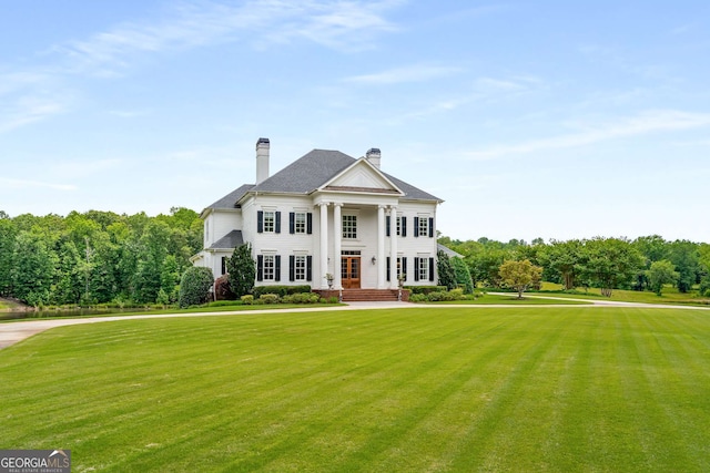 greek revival house featuring a front lawn