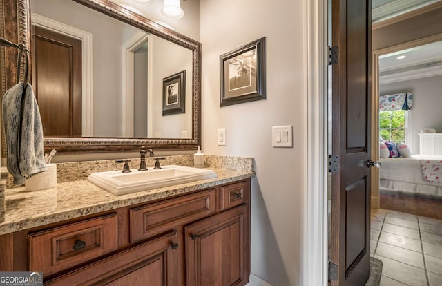 bathroom featuring tile patterned flooring, vanity, and ornamental molding