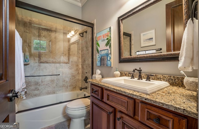 full bathroom with combined bath / shower with glass door, vanity, toilet, and ornamental molding