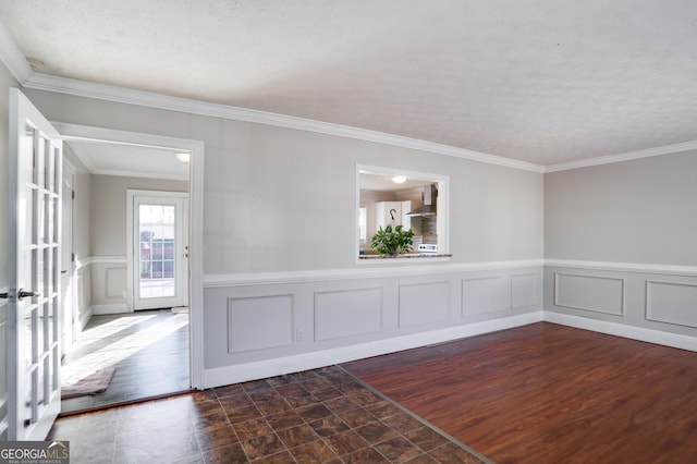 spare room with a textured ceiling and ornamental molding