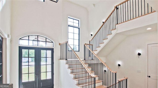 entrance foyer with a high ceiling and french doors