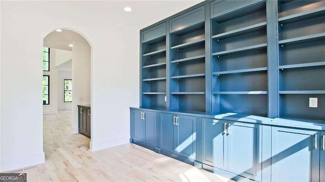 interior space with built in shelves and light wood-type flooring