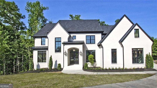 view of front facade featuring french doors and a front yard