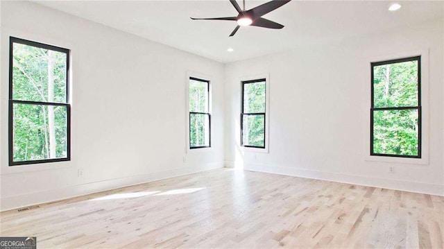 empty room featuring ceiling fan and light wood-type flooring