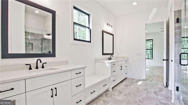 bathroom featuring vanity and a shower with shower door