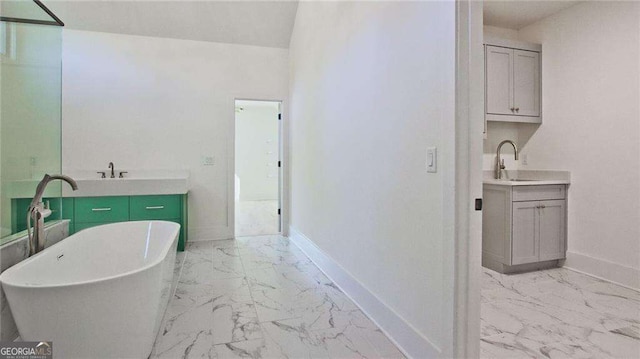 bathroom featuring a washtub and vanity