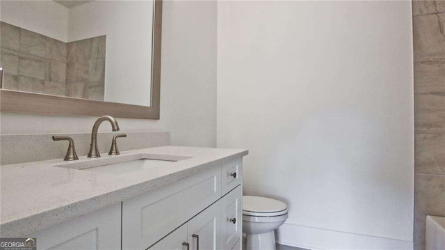 bathroom with vanity and toilet