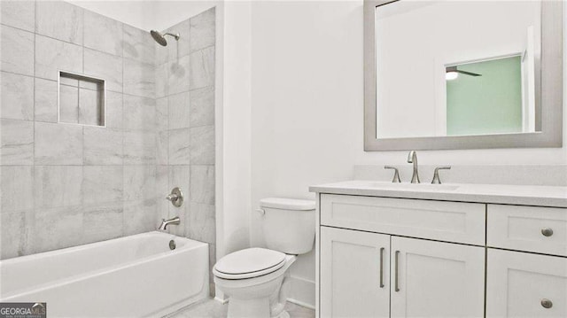 full bathroom featuring toilet, vanity, and tiled shower / bath