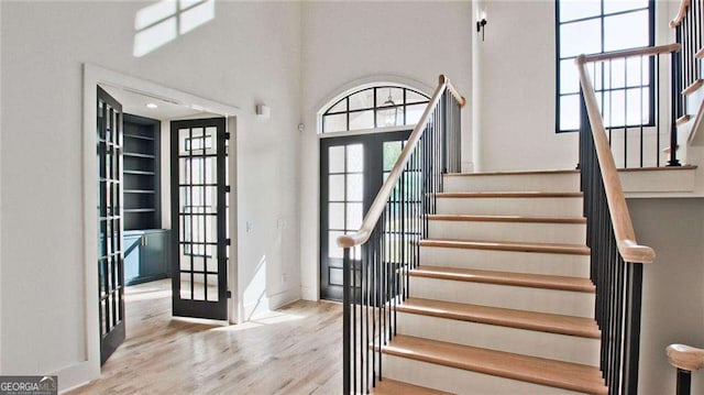 foyer entrance featuring light hardwood / wood-style floors and french doors