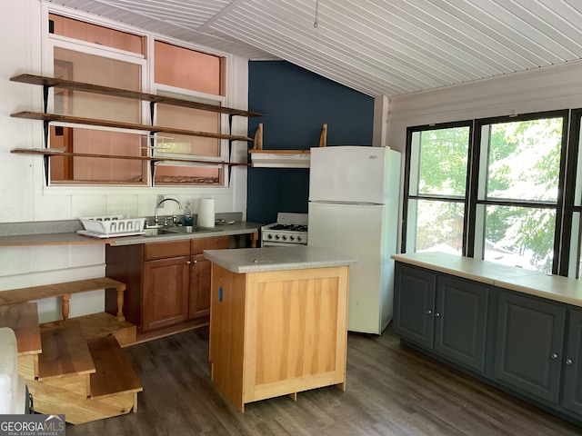 kitchen featuring a center island, dark hardwood / wood-style floors, white appliances, and sink