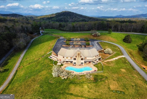 birds eye view of property with a mountain view