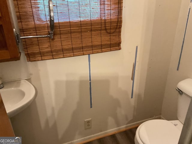 bathroom featuring sink, toilet, and hardwood / wood-style flooring