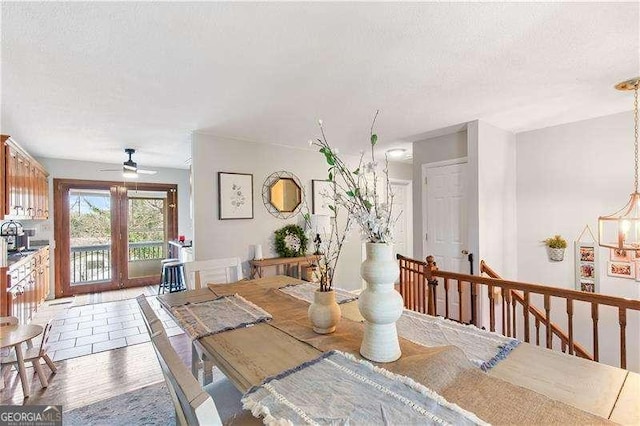 dining area featuring a textured ceiling, ceiling fan, and hardwood / wood-style flooring