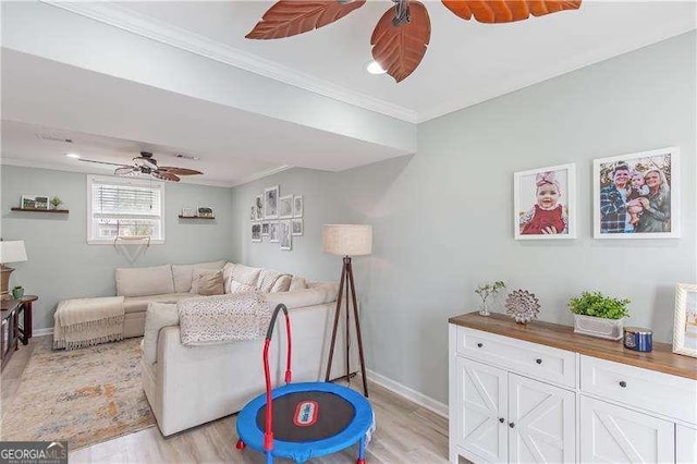 living room with light hardwood / wood-style floors and crown molding