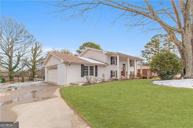 split level home with a front lawn and a garage