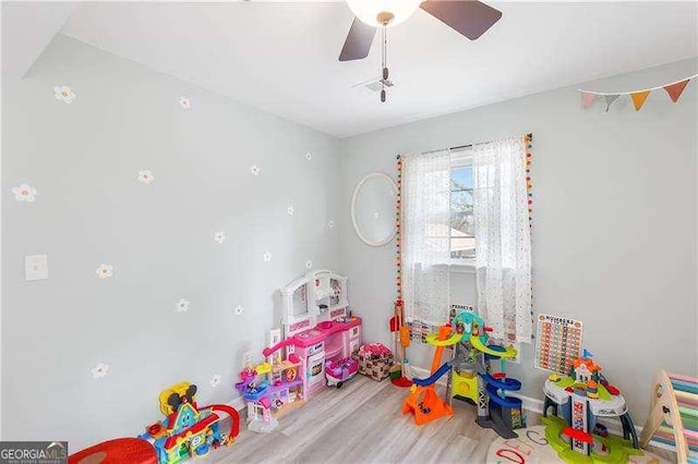 rec room with ceiling fan and wood-type flooring