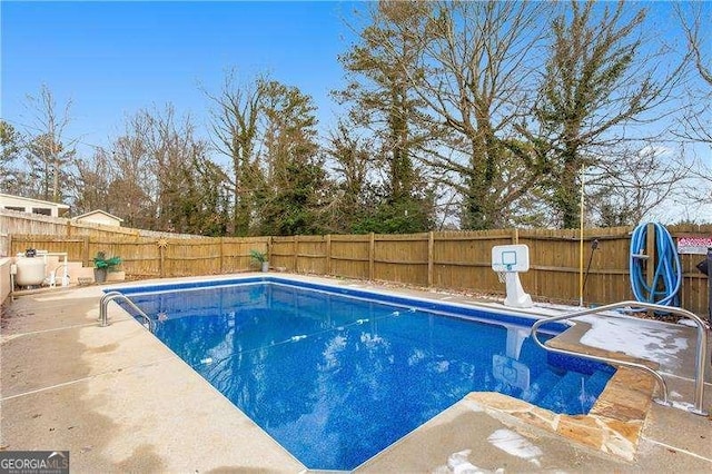 view of swimming pool with a patio