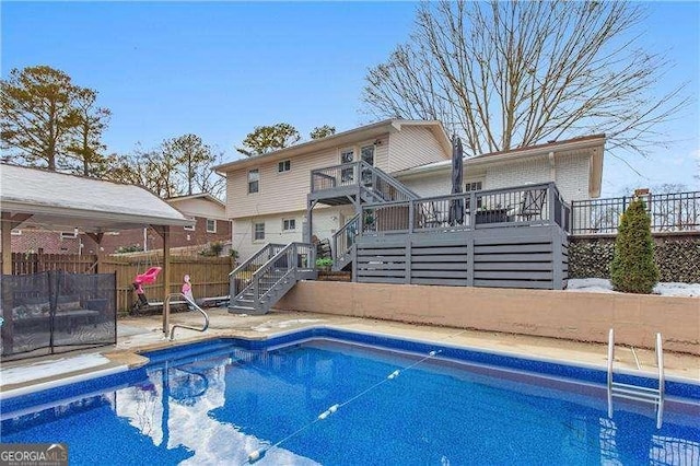 view of swimming pool featuring a wooden deck