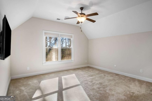 additional living space with ceiling fan, light carpet, and lofted ceiling