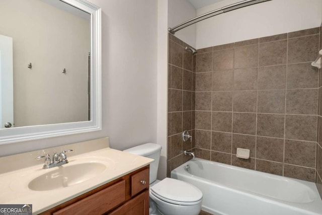 full bathroom with toilet, vanity, and tiled shower / bath