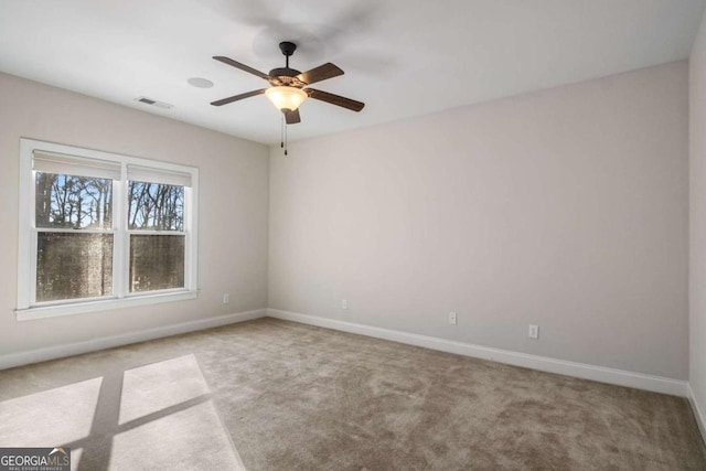 carpeted empty room featuring ceiling fan