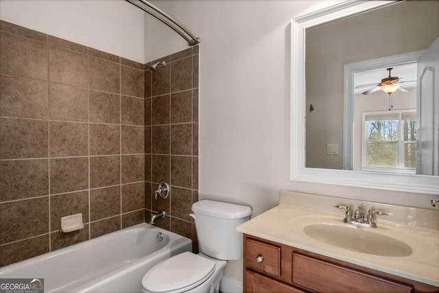 full bathroom with toilet, vanity, tiled shower / bath combo, and ceiling fan