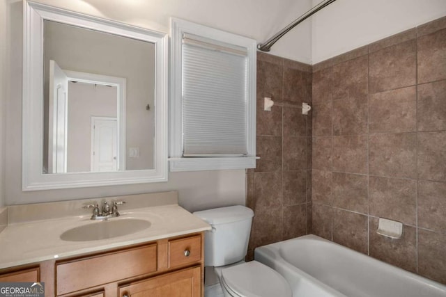 full bathroom with tiled shower / bath combo, vanity, and toilet