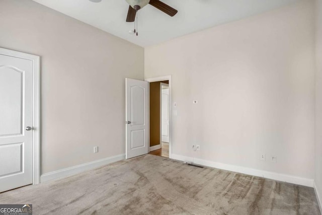 unfurnished bedroom featuring light colored carpet and ceiling fan